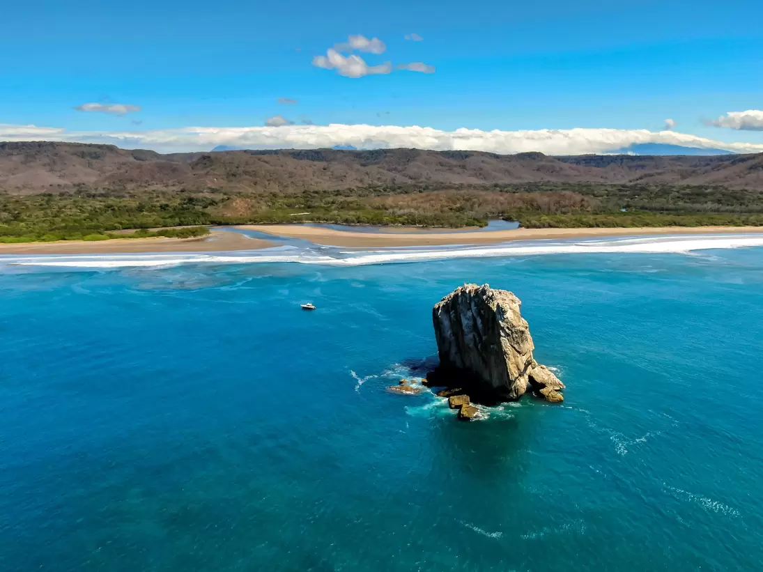 Beautiful aerial view of a sunset in Naranjo Beach - Witch Rock, Costa Rica.