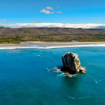 Beautiful aerial view of a sunset in Naranjo Beach - Witch Rock, Costa Rica.