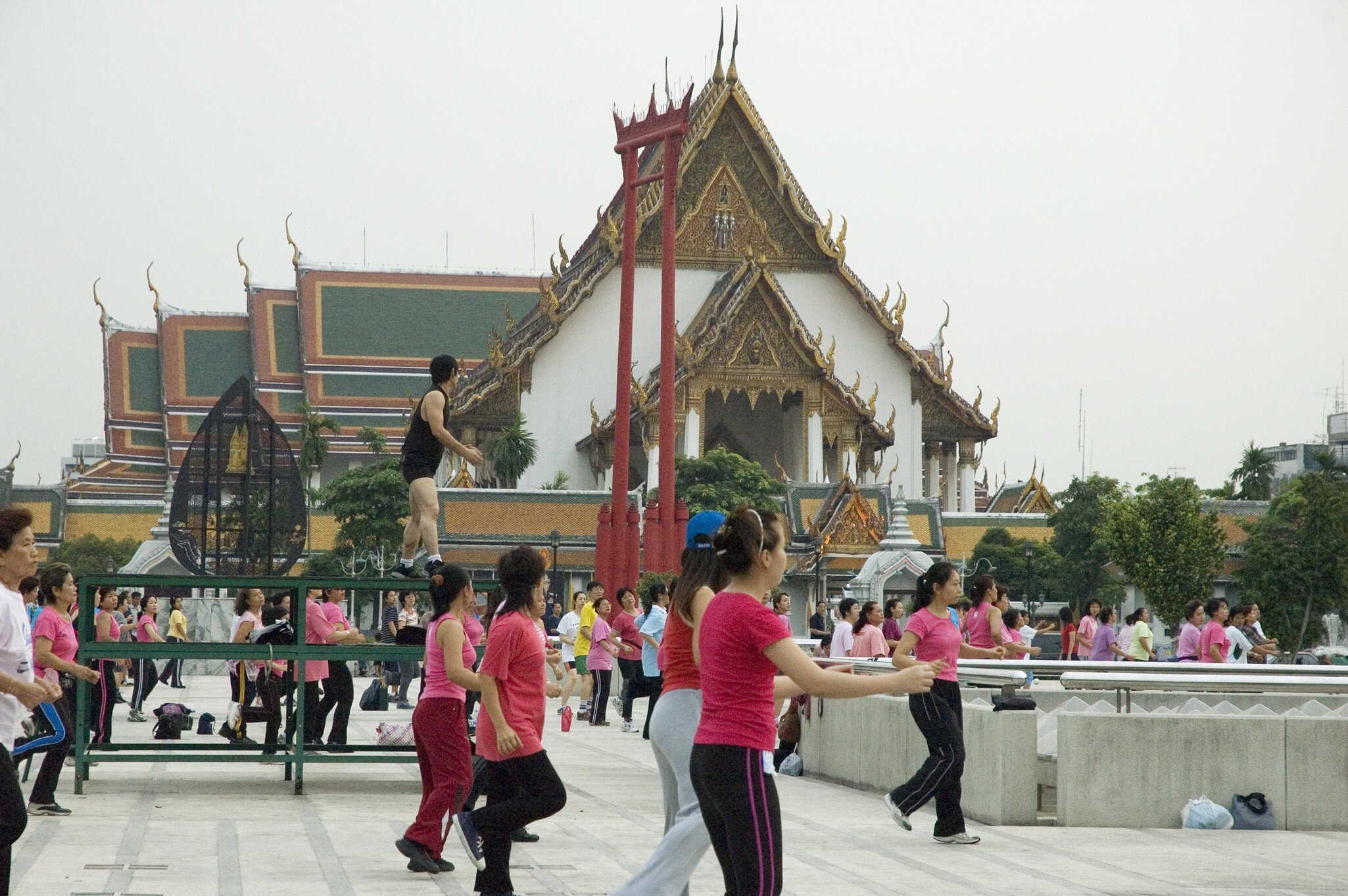 23281-51
Asia, Bangkok, South-East Asia, Thailand, activity, adult, architecture, asian, building, colourful, compatible, concrete, contrast, culture, day, energy, exterior, facade, female, fitness, group of people, health, large group of people, leadership, lifestyle, male, mixed age range, mixed gender, order, outdoors, people, public space, repetition, side view, sky, south east asian, sport & recreation, square, structure, temple, unity, unusual, urban
People exercising in front of Sao Ching-Cha (Giant Swing), with Wat Suthat in background.