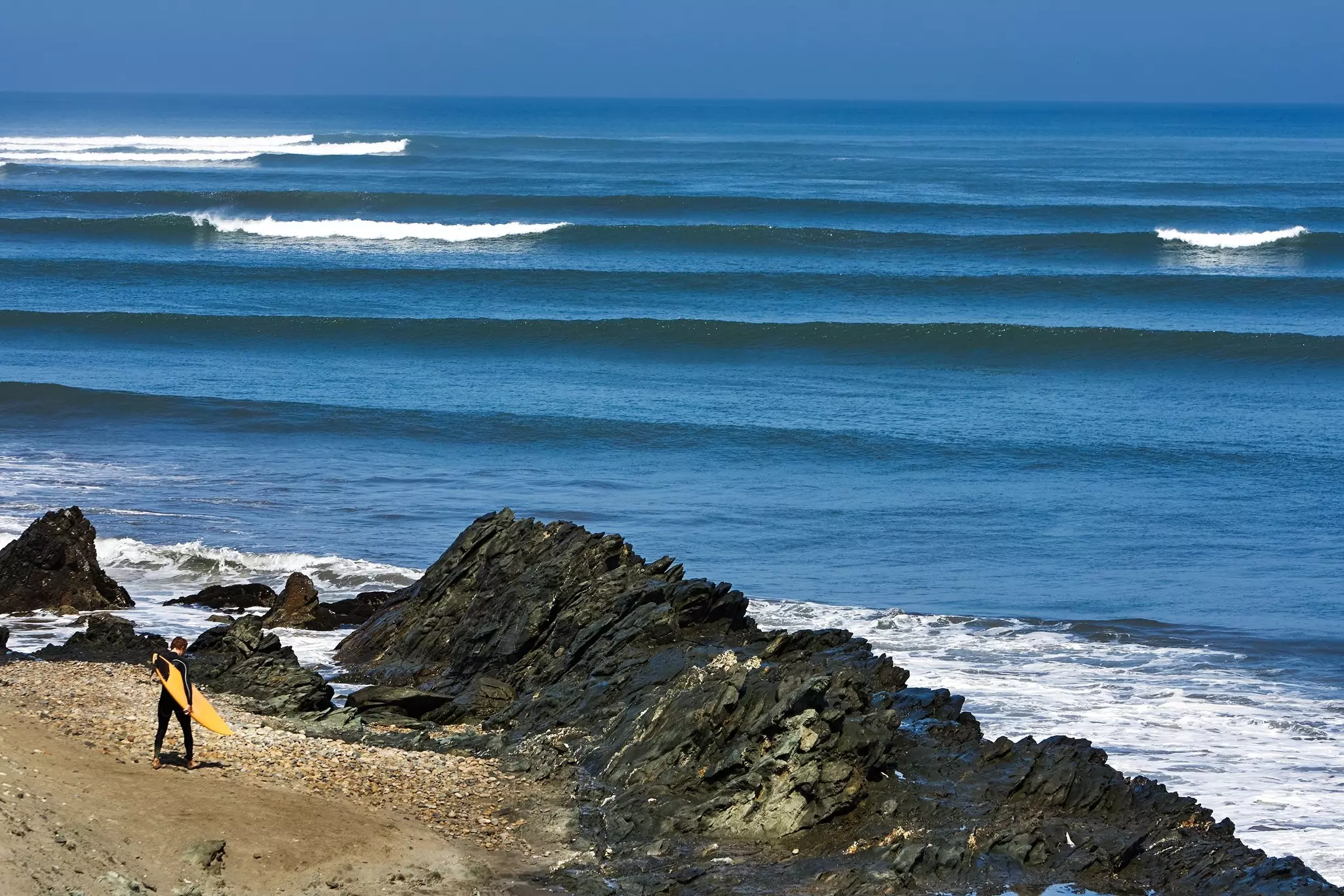 A surfer surveys the waves at Chicama in northern Peru. 
