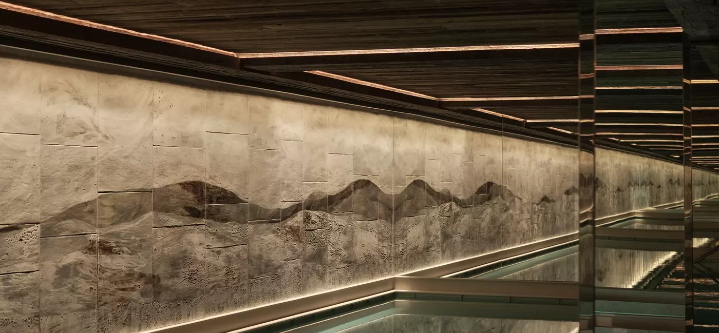 A series of small pools along a wall in a spa: Rosewood Courchevel