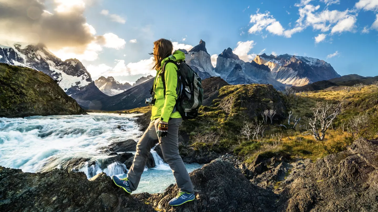 Female hiker walking on rocky ground near Salto Grande Waterfall