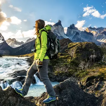 Female hiker walking on rocky ground near Salto Grande Waterfall