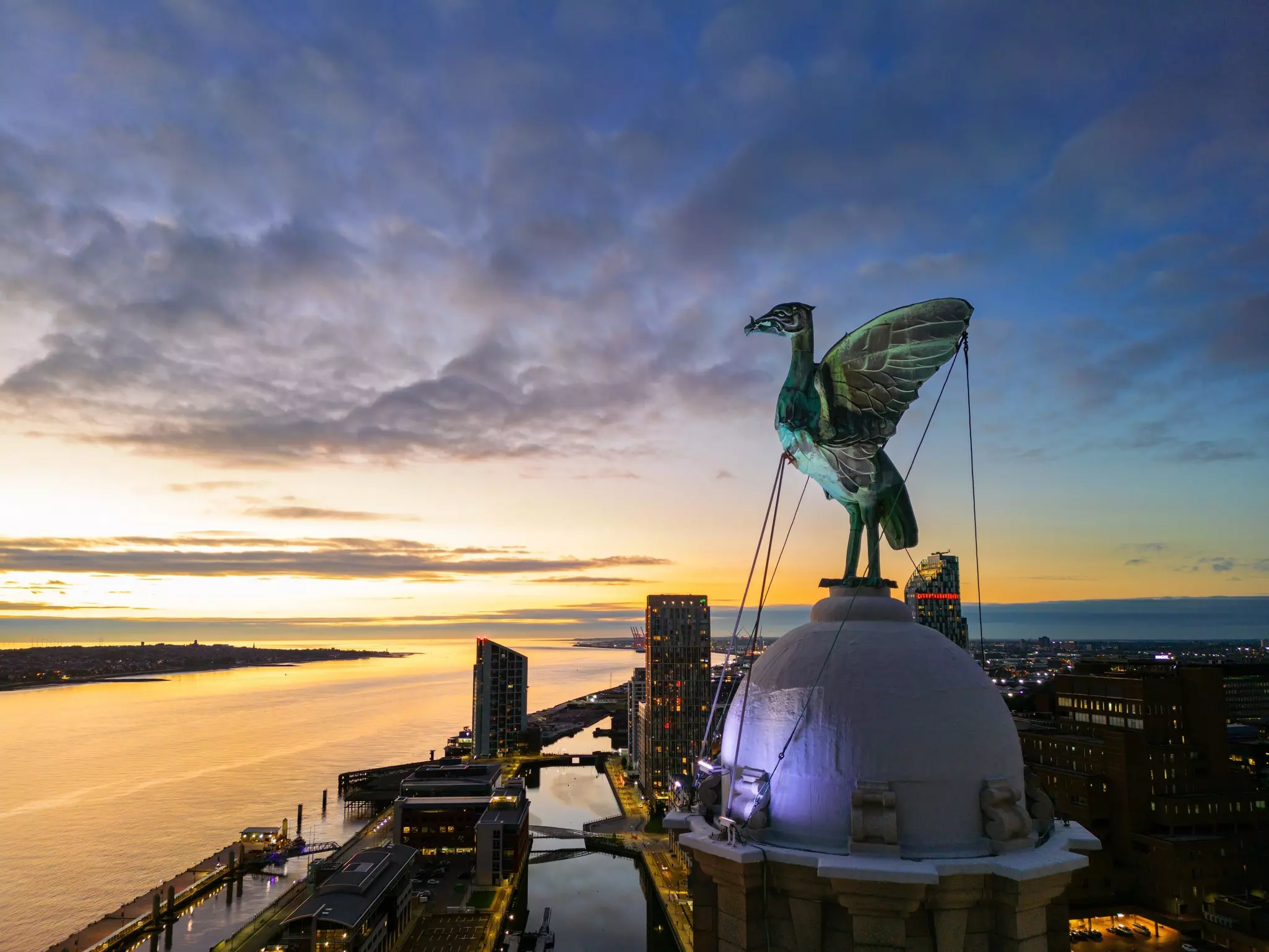 Aerial close up Night Time view of the Liver Bird on the Royal Liver Building, Pier Head Waterfront after a Stunning Sunset, Liverpool, England.
