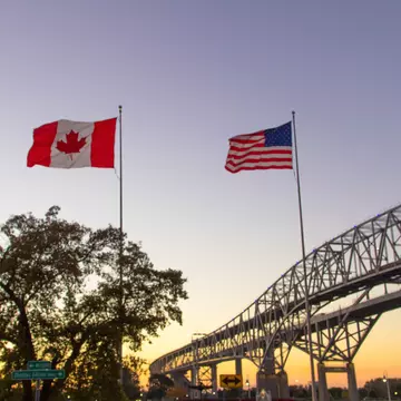 The twin spans of the Blue Water Bridges international crossing between the cities of Port Huron, Michigan and Sarnia, Ontario is one of the busiest border crossings between Canada and the United States.
1126897734
michigan, usa, travel, bridge - built structure, port huron, midwest usa, canada, sarnia, ontario - canada, cityscape, illuminated, dawn, morning, urban skyline, panoramic, city, urban road, waterfront, famous place, geographical border, emigration and immigration, customs, travel destinations, tourism, transportation, road, crossing, sunrise - dawn, downtown district, great lakes, architecture, night, dusk, river, road trip, built structure, large, two objects, no people, blue, twilight, canadian flag, american flag, department of homeland security, landscape - scenery, Twilight, Outdoors, Travel Destinations, Horizontal, Sunrise - Dawn, Transportation, Built Structure, Ontario - Canada, Cityscape, Architecture, Crossing, Downtown District, Large, Geographical Border, Two Objects, Road Trip, Bridge - Built Structure, Emigration and Immigration, River, Panoramic, Dawn, Custom, Night, USA, City, Waterfront, Tourism, Port Huron, Photography, Urban Road, American Flag, Road, Michigan, Illuminated, Canada, Twilights, Travel, Great Lakes, Department of Homeland Security, Illumination, Blue, Morning, No People, Dusk, Canadian Flag, Customs, Famous Place, Landscape - Scenery, North America, Sarnia, Midwest USA, Urban Skyline