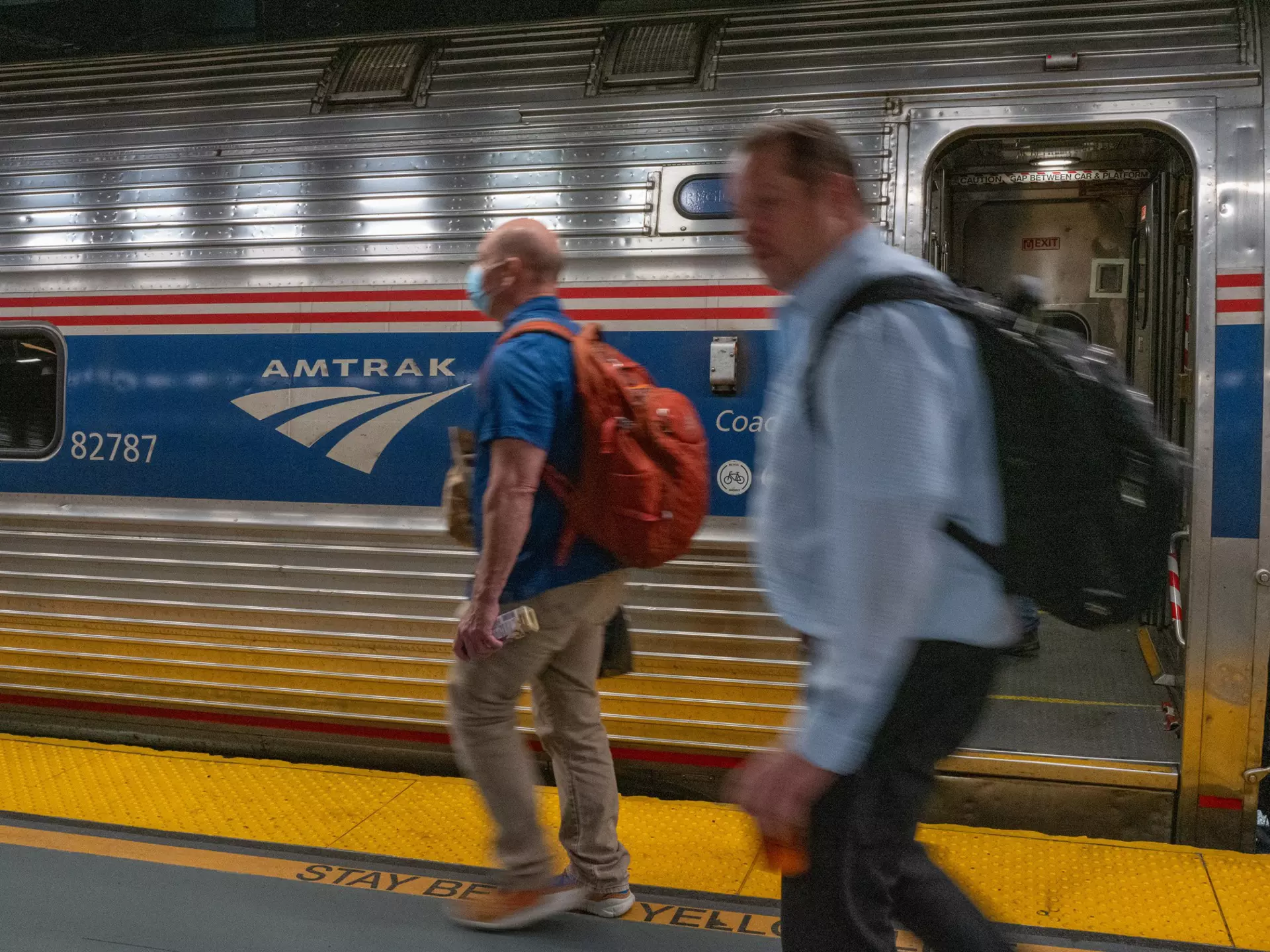 People walk to an Amtrak train in the Moynihan Train Hall on September 15, 2022 in New York City.