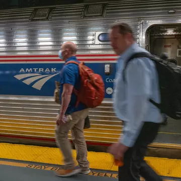 People walk to an Amtrak train in the Moynihan Train Hall on September 15, 2022 in New York City.