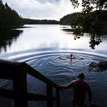 Bathing in Lake Saimaa after a sauna in Finland