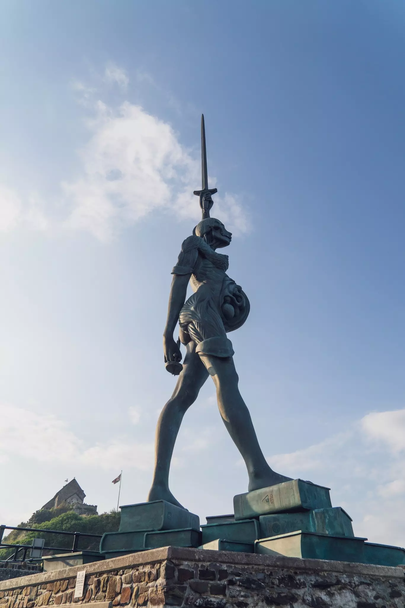 North Devon, England, UK: September 25, 2024: Ilfracombe,  - Woman sculpture at the harbour. Verity sculpture at Ilfracombe harbour, near the Chapel of St Nicholas.