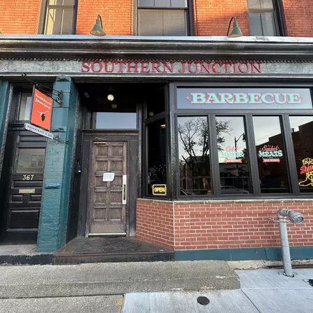 The outside of a brick building with a sign reading Southern Junction Barbecue
