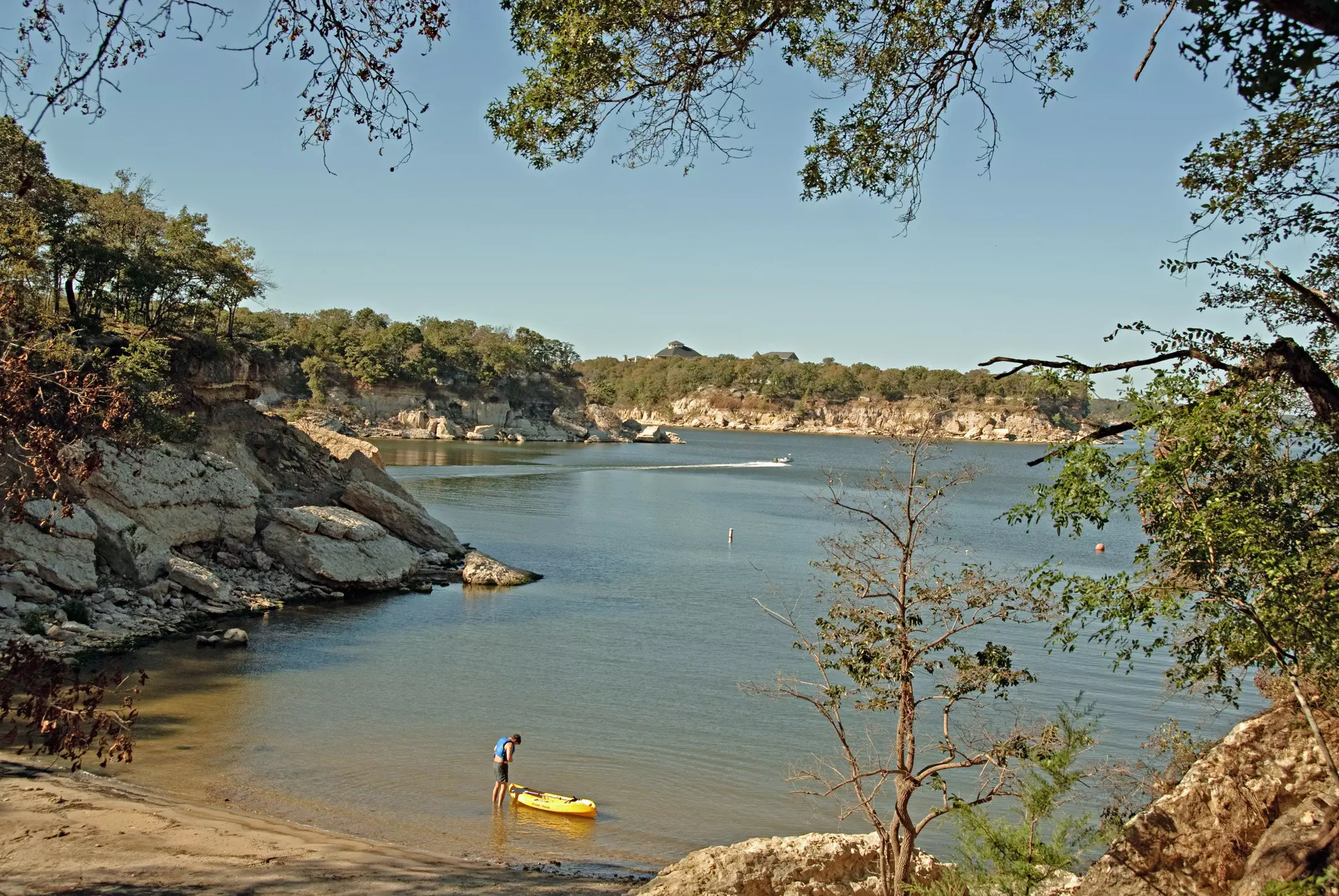 View of Lake Texoma at Eisenhower State Park outside Denison Texas and a man putting on his life vest to go kayaking