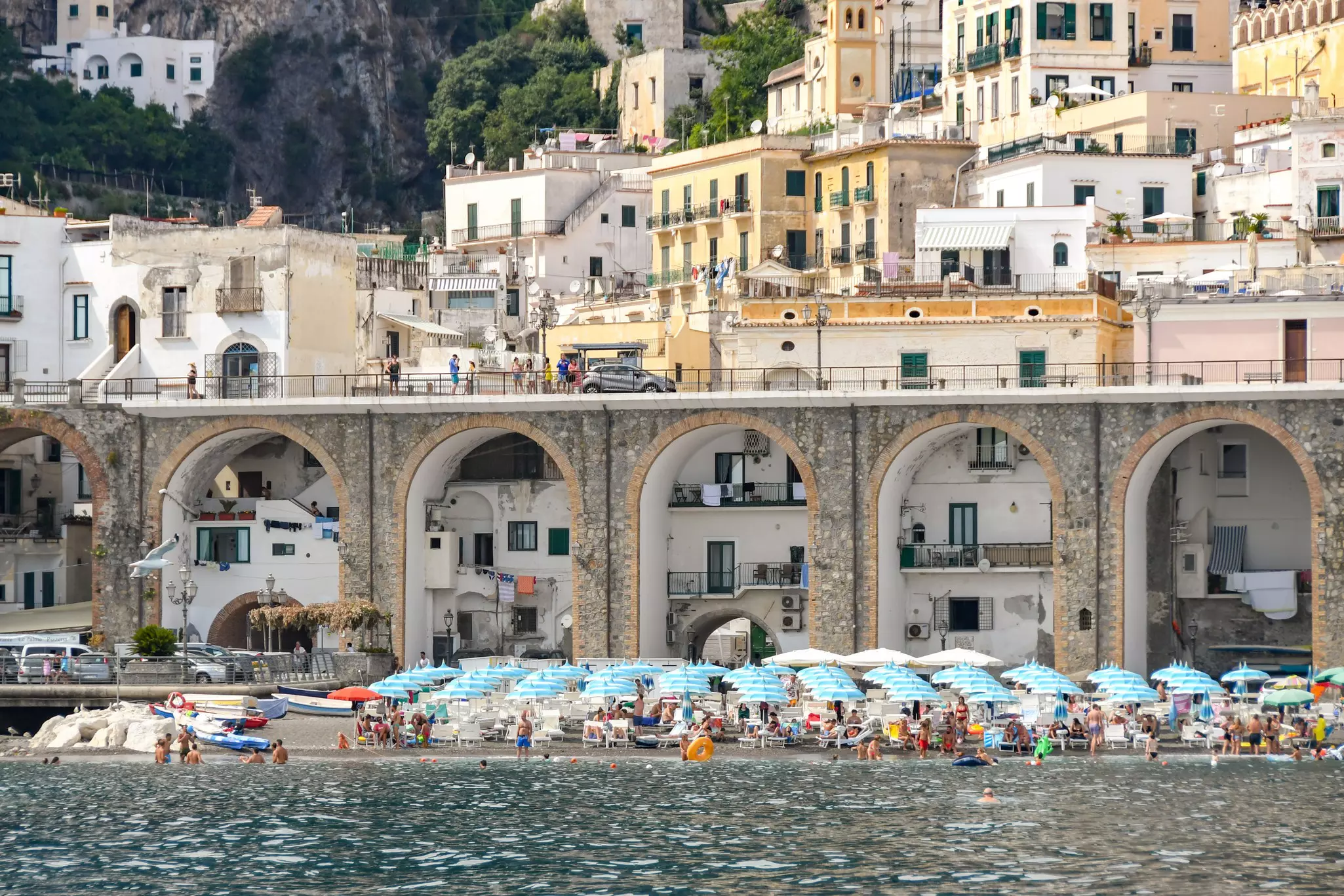 Houses built into the arches of a bridge carrying the Amalfi Drive through the village of Atrani