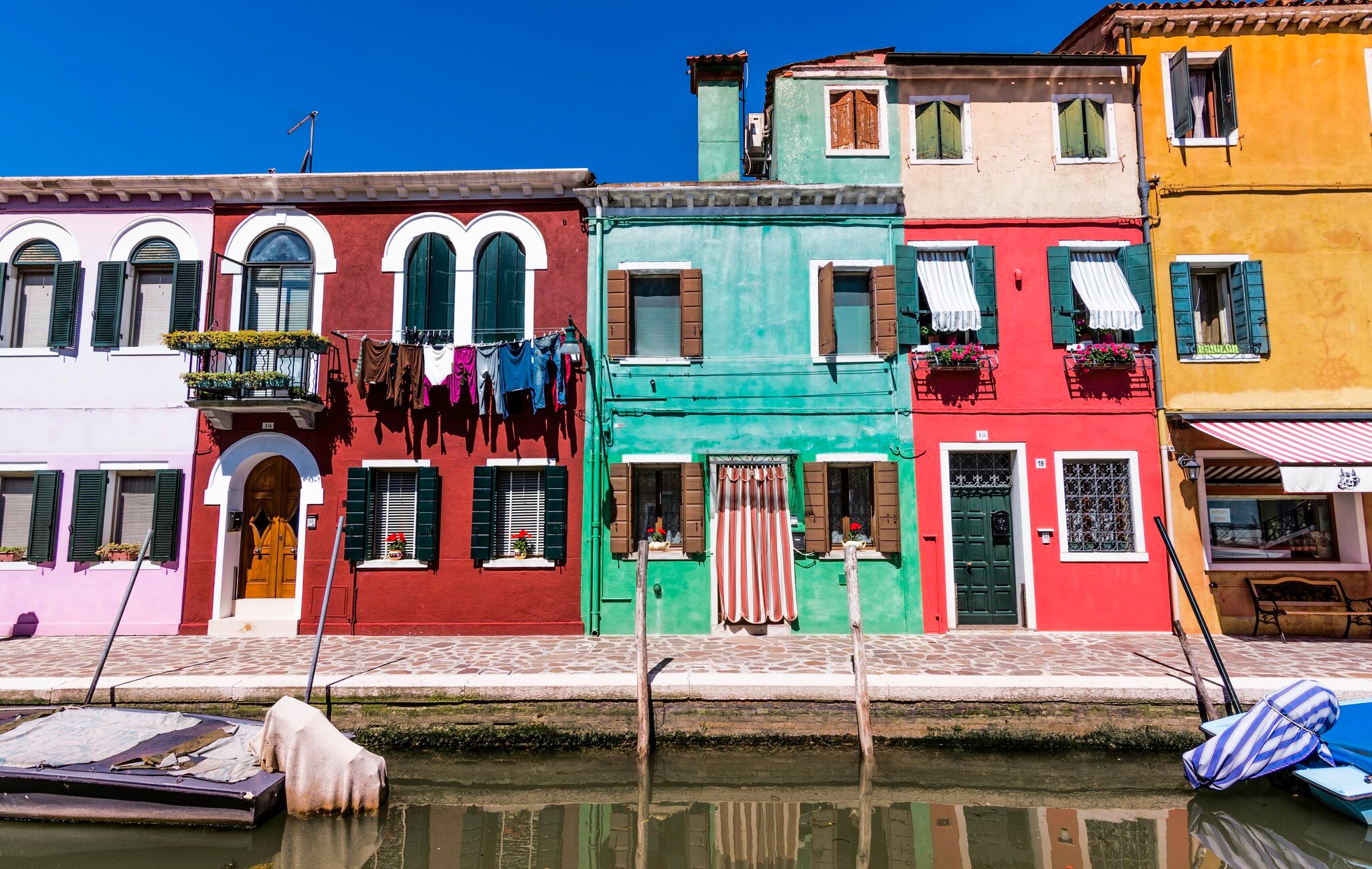 Colourful row houses by canal, Burano.