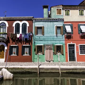 Colourful row houses by canal, Burano.