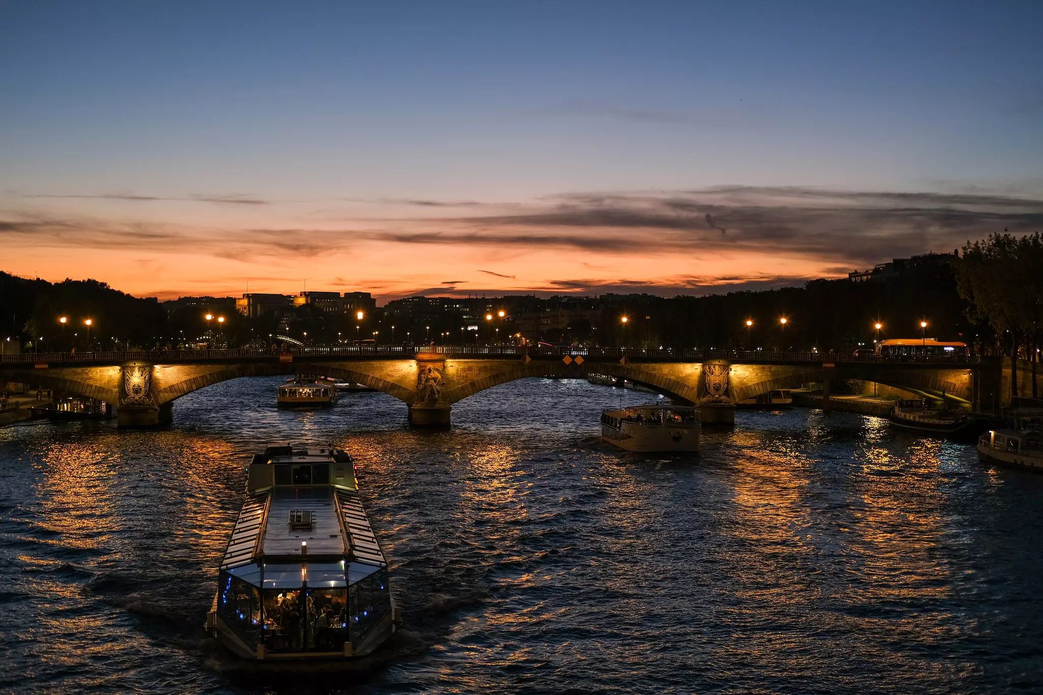 Tourist boat on Seine river  at sunset