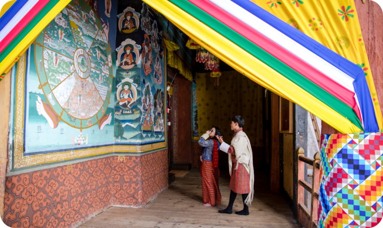 Two people viewing a mural.