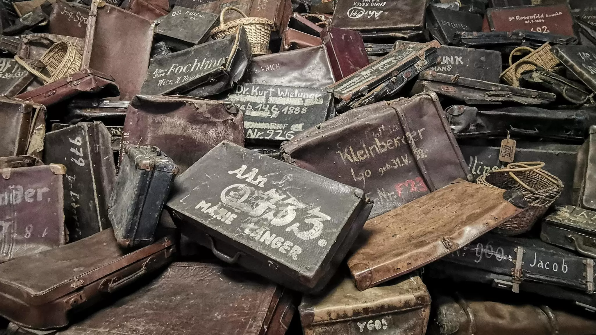 A huge pile of suitcases belonging to victims of the Holocaust at Auschwitz-Birkenau in Poland.