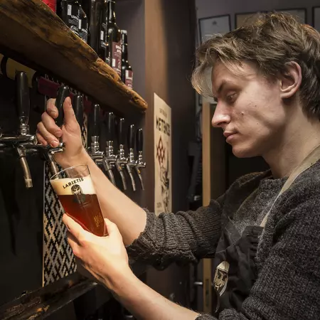 Barman pouring beer at Labietis.