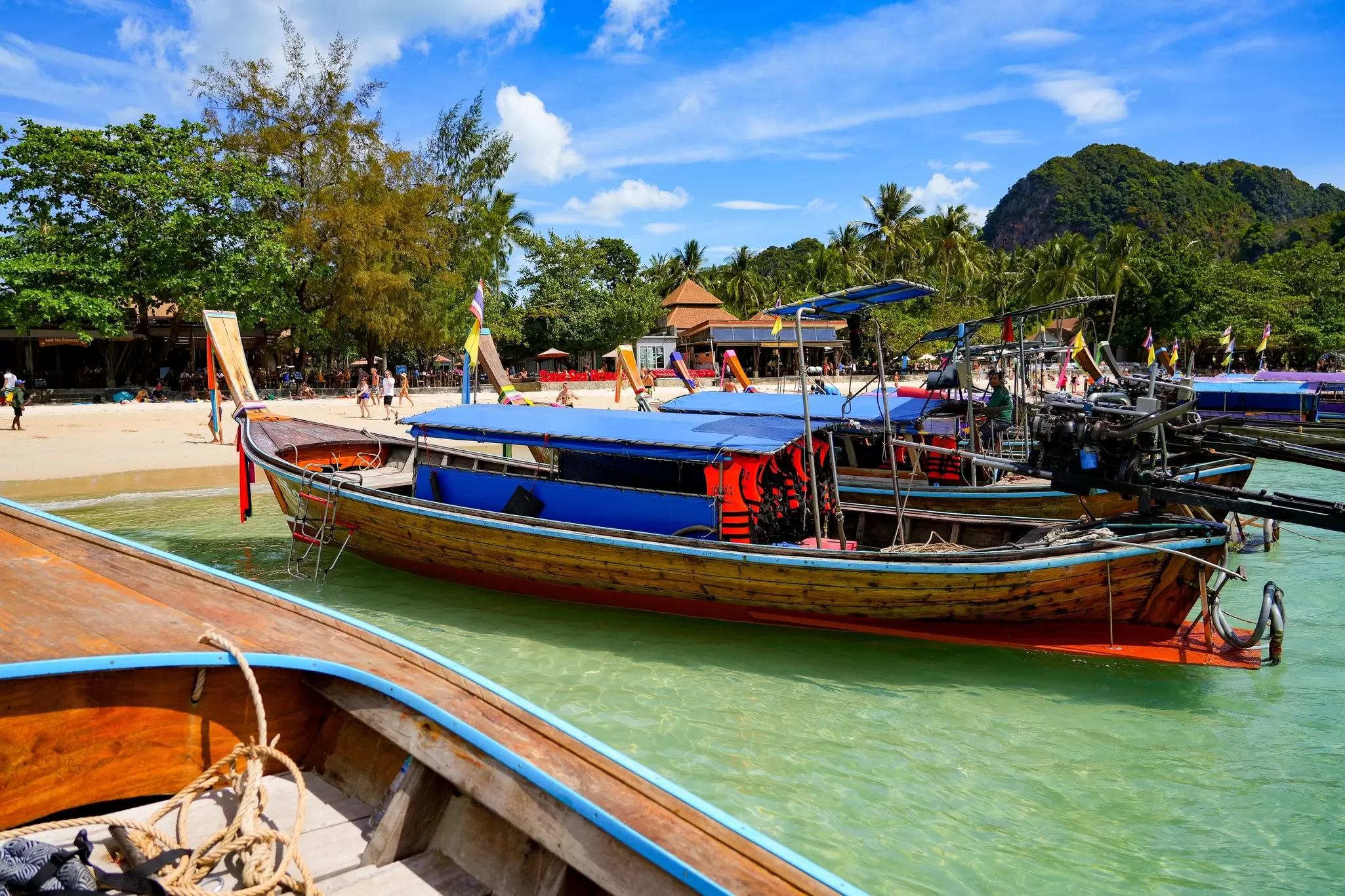 View of traditional long-tail boats on Railay West Beach on the Railay Peninsula in the Province of Krabi, Thailand.