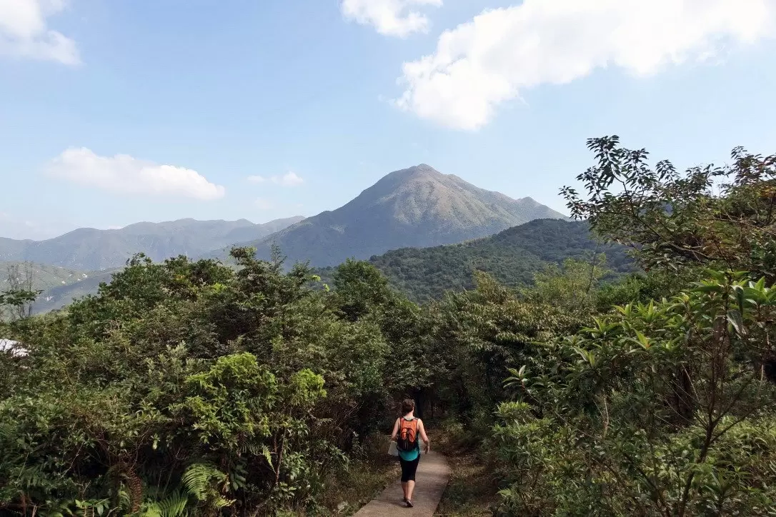 A hiker walks along a path towards Lantau Peak in Hong Kong.