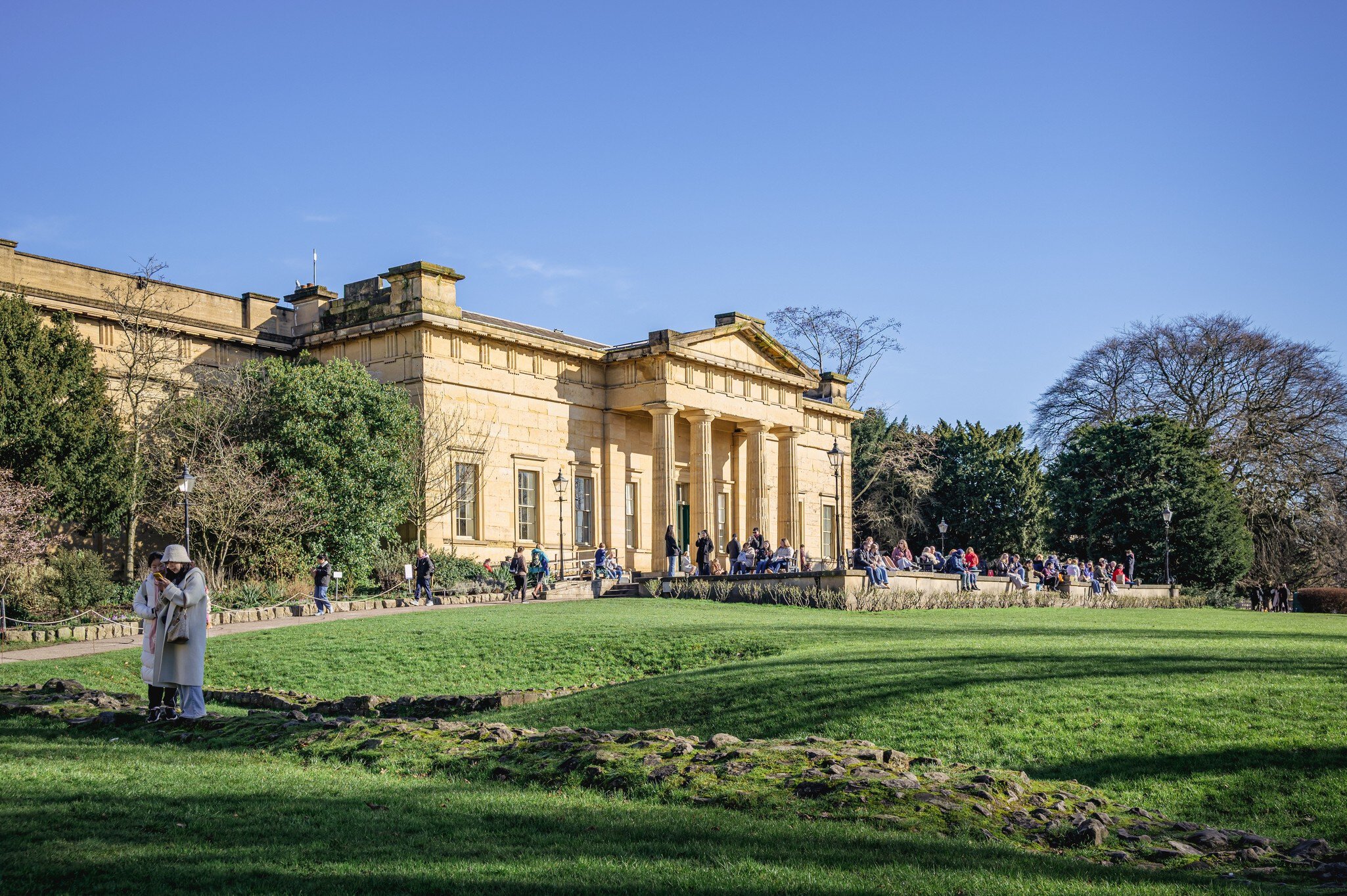 York, UK. February 14, 2026. Yorkshire Museum building in the architectural Greek Revival style with doric columns supporting a pediment above.  A lawn is in front of the building and a part of a ruin is in the foreground., License Type: media, Download Time: 2026-04-25T01:30:17.000Z, User: LP_ZRay, Editorial: true, purchase_order: 65050 - Digital Destinations and Articles, job: Lonely Planet, client: App Content, other: Zayira Ray