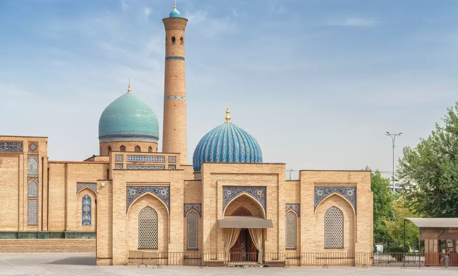 Hazrati Imam complex in Tashkent, Uzbekistan: sandstone mosque with two turquoise domes and a tall brick minaret