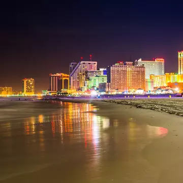 Atlantic City skyline lit up at night, as seen from the beach.
213973513
downtown, coast, shore, travel, waterfront, sand, urban, architectural, bright, night, scenery, skyline, light, clouds, building, dark, modern, casinos, beach, reflection, architecture, city, blue, outdoors, sky, scenic, hotels, tourism, sea, beautiful, water, nature, landscape, ocean, new, exposure, jersey, long, atlantic