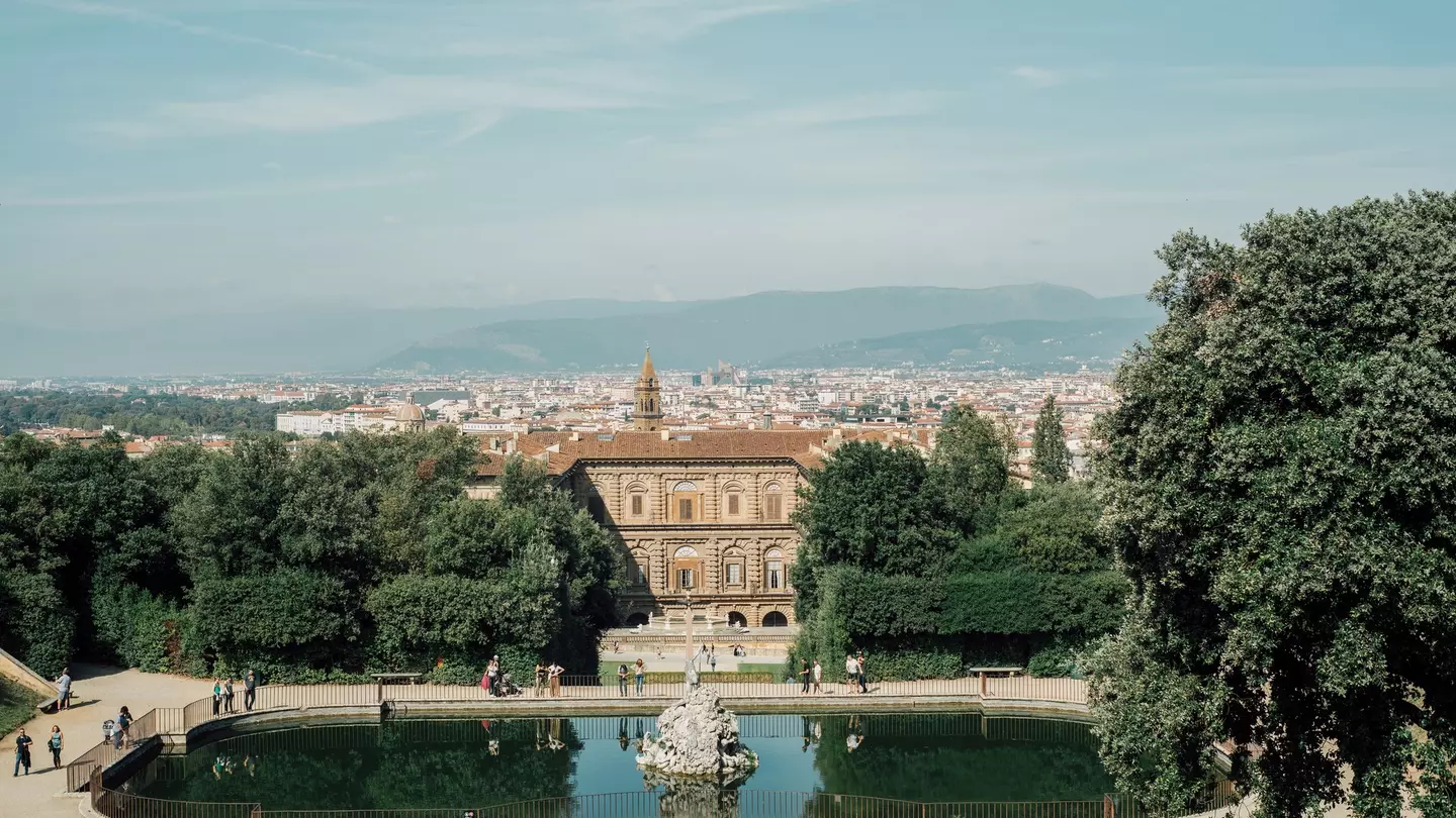 Boboli Gardens as seen from Palazzo Pitti, with pedestrians strolling on a slightly overcast day
