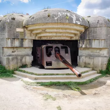 German defense battery against allied troops debarquement, bunker ruins with rusty gun at Longues sur Mer, Normandy, France.