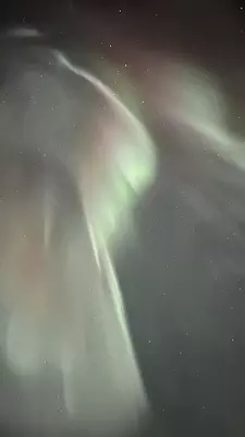 Swirls of white against a dark starry sky in Alaska.