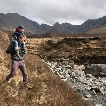 Father and son hiking, Fairy Pools, Isle of Skye, Hebrides, Scotland