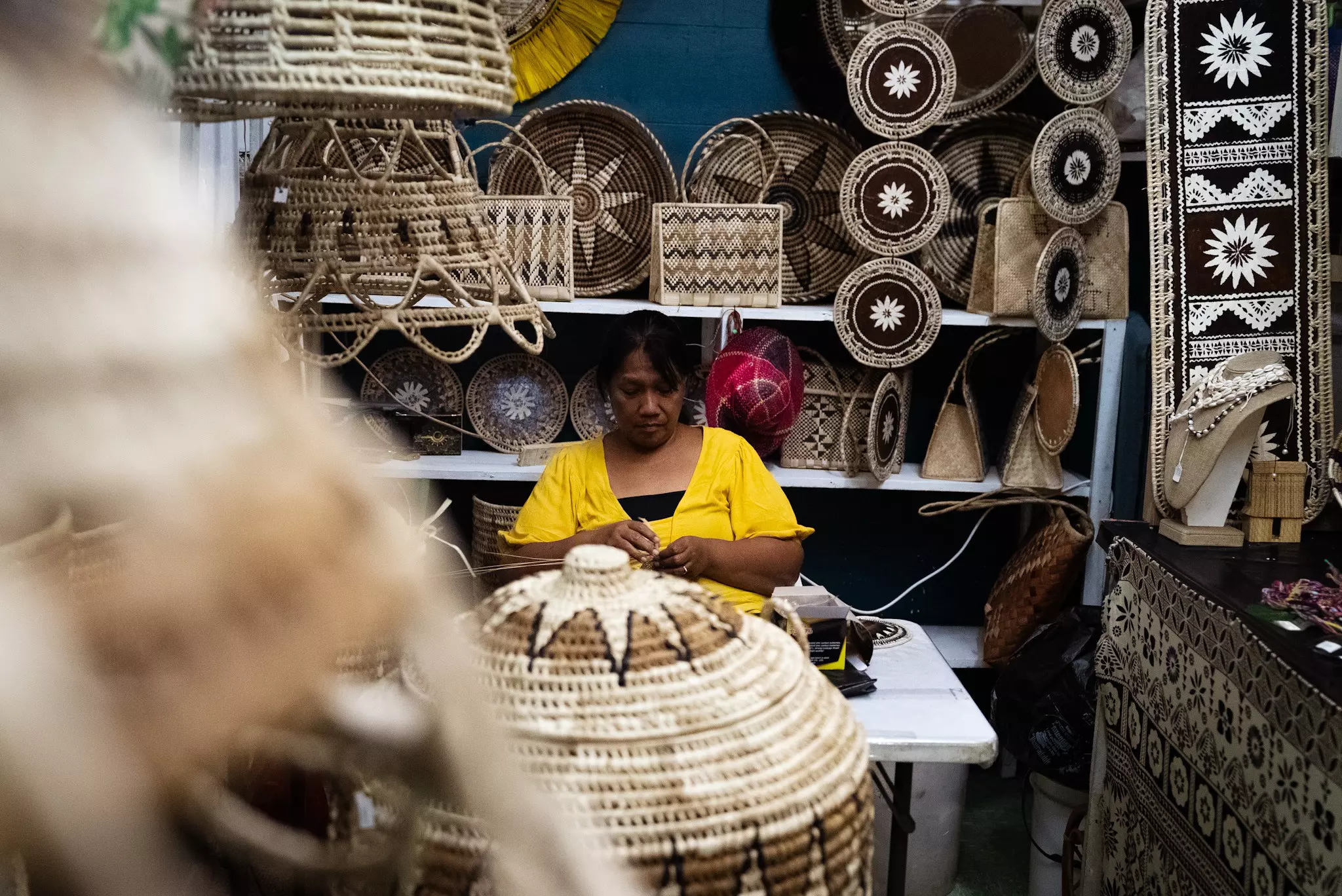 A woman selling handmade woven baskets in Suva, Fiji