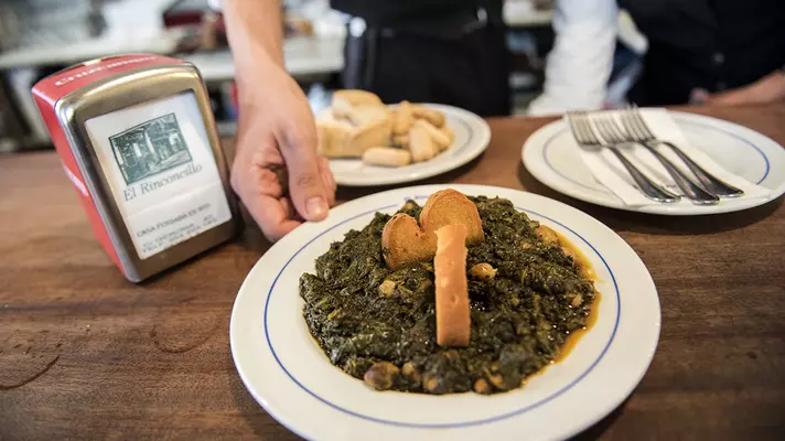 A waiter slices jamón Ibérico