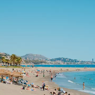People swimming at Malagueta beach in Málaga, Spain.
