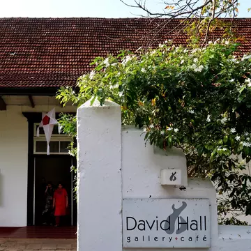 A group of tourists exiting David Hall art gallery in Fort Kochi, Kerala. India.