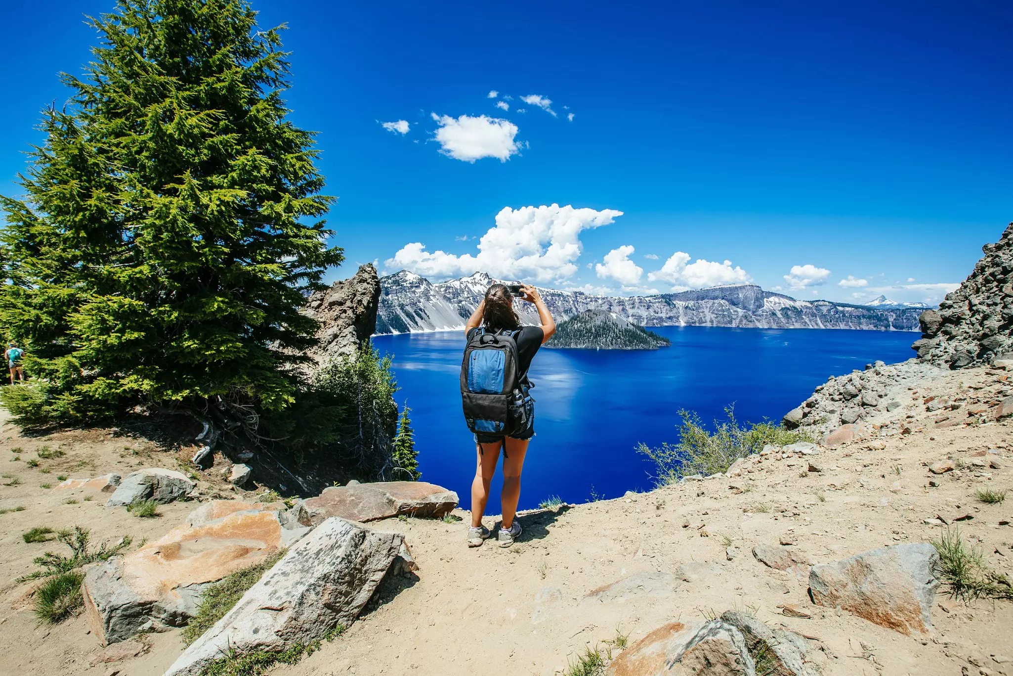 A backpacker stops to take in the splendor of Crater Lake National Park, Oregon