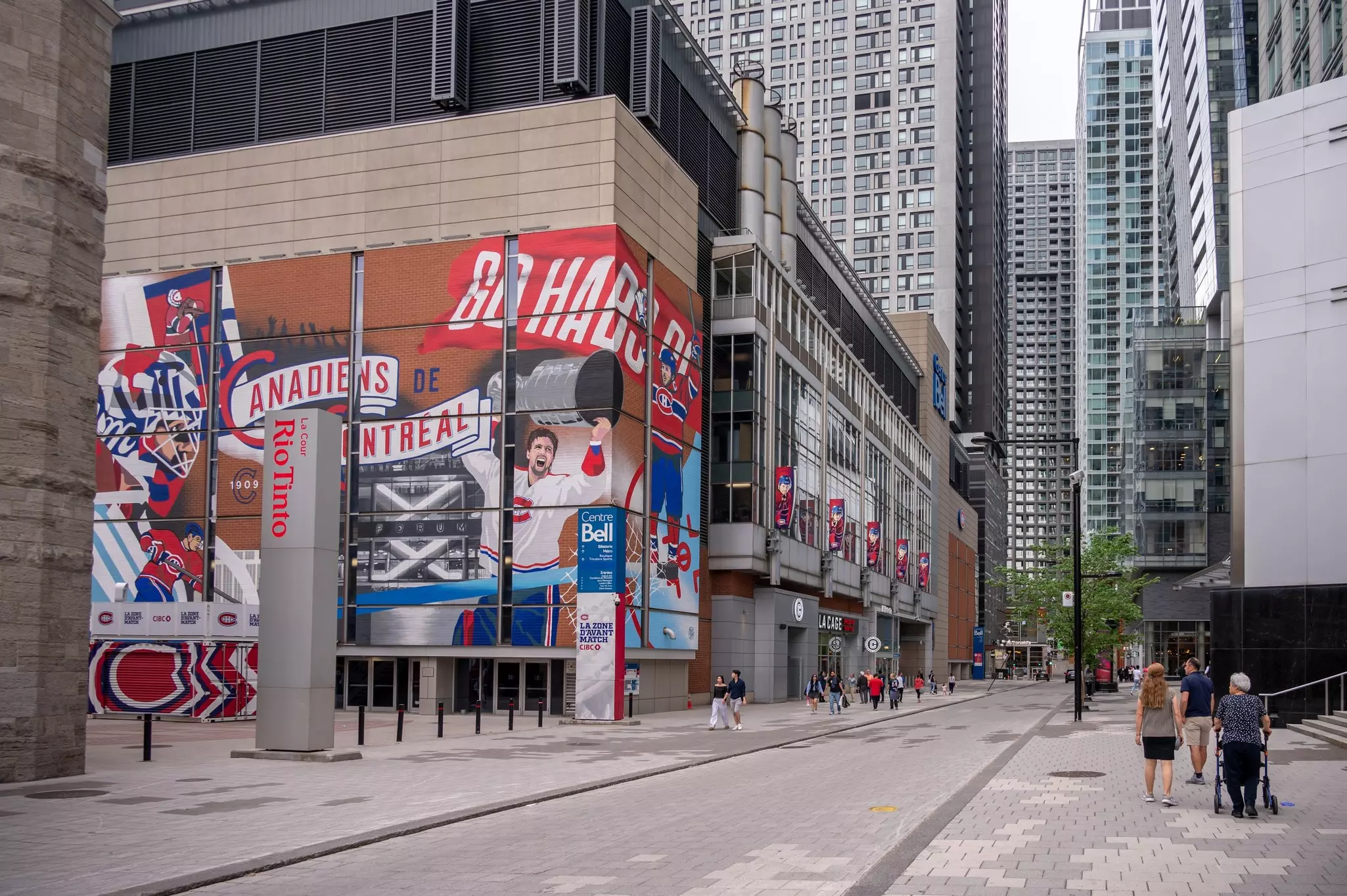 A sports center with a huge mural of a player holding a trophy aloft