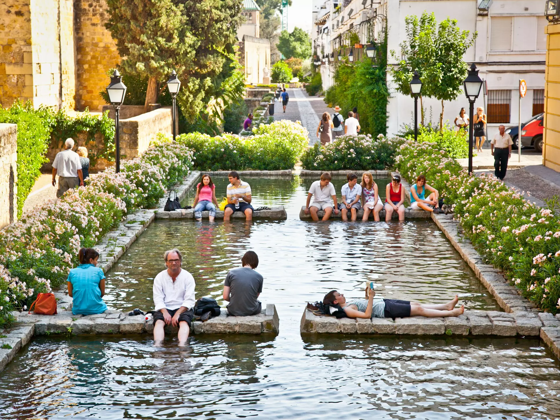 People relaxing in fountain in Cordoba, Spain. Aleksandar Todorovic/Shutterstock