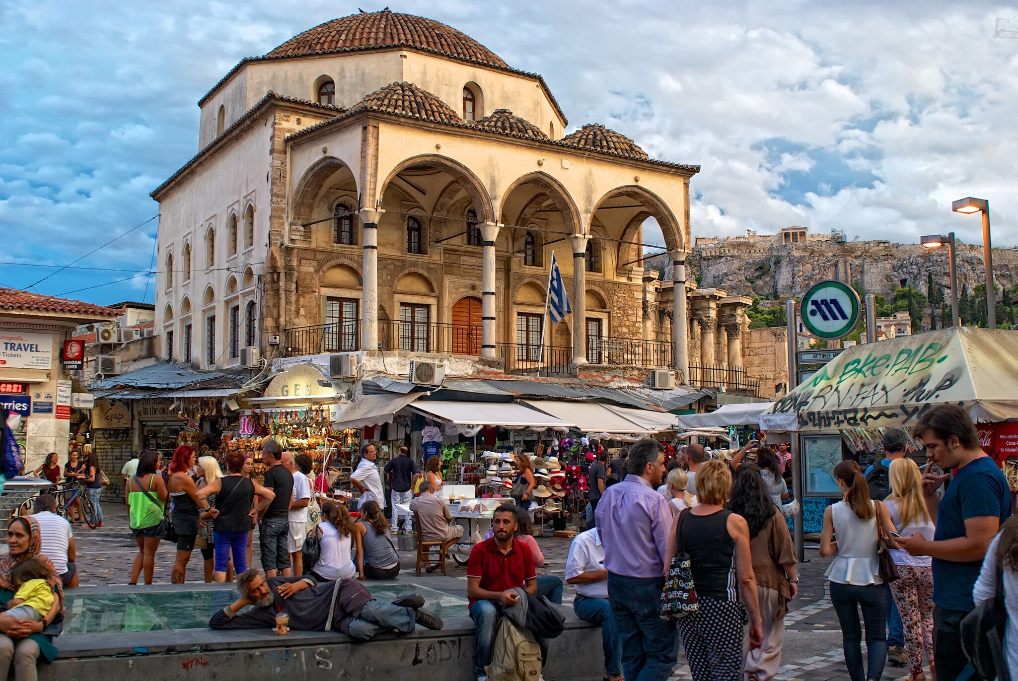 Athens, Greece - September,7. 2014. People walk on the Monastiraki Square. Tzistarakis Mosque is an Ottoman mosque, built in 1759, in Monastiraki Square, central Athens. View of the Acropolis.; Shutterstock ID 233174752; your: Erin Lenczycki; gl: ...