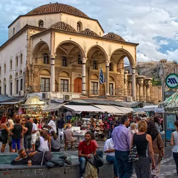Athens, Greece - September,7. 2014. People walk on the Monastiraki Square. Tzistarakis Mosque is an Ottoman mosque, built in 1759, in Monastiraki Square, central Athens. View of the Acropolis.; Shutterstock ID 233174752; your: Erin Lenczycki; gl: ...
