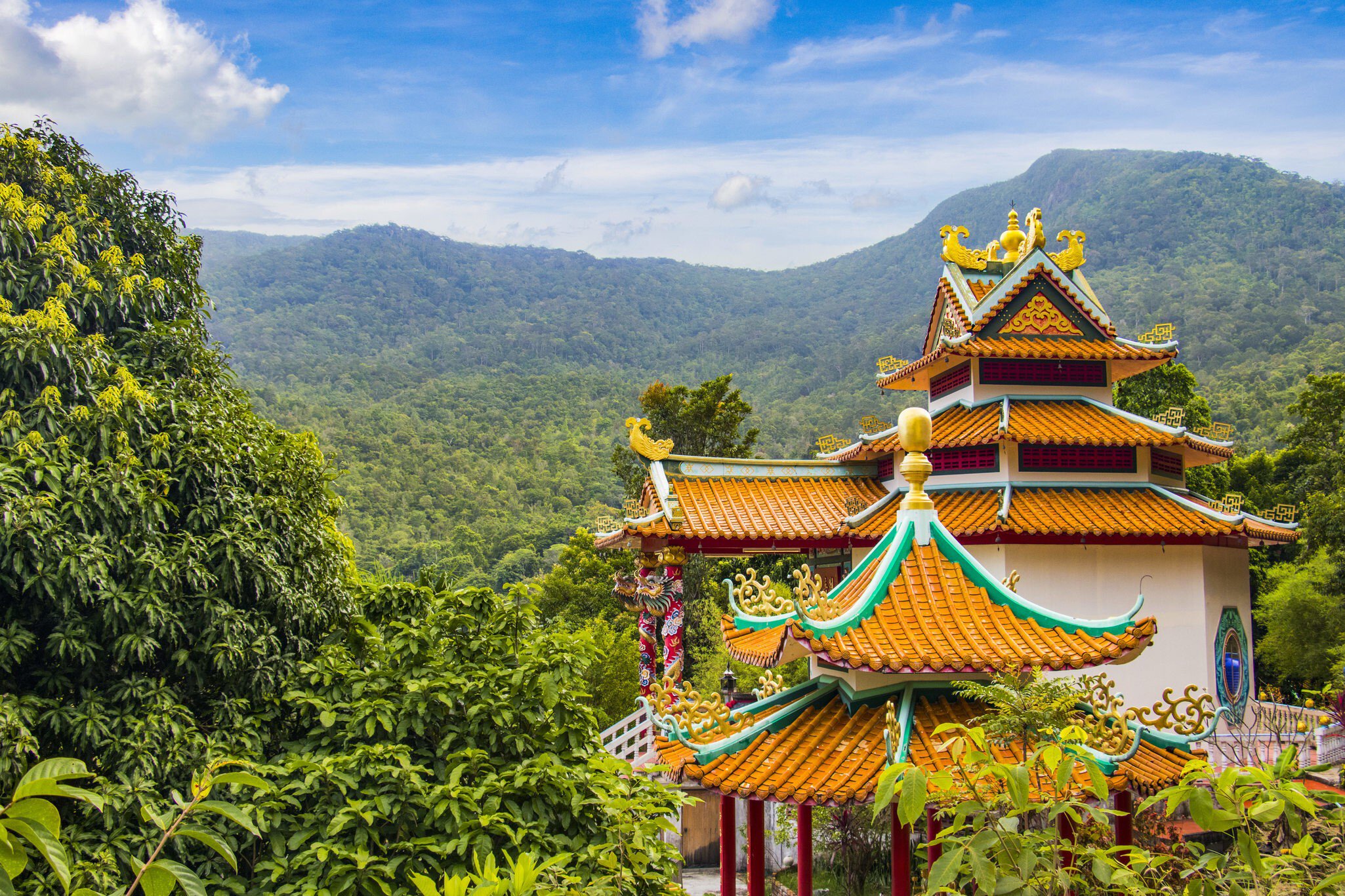Exterior of the Chinese Temple Guan Yin, set among the rainforest of Ko Pha-Ngan, Thailand. Greenery surrounding.
