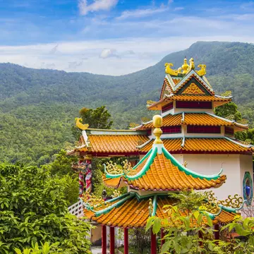Exterior of the Chinese Temple Guan Yin, set among the rainforest of Ko Pha-Ngan, Thailand. Greenery surrounding.