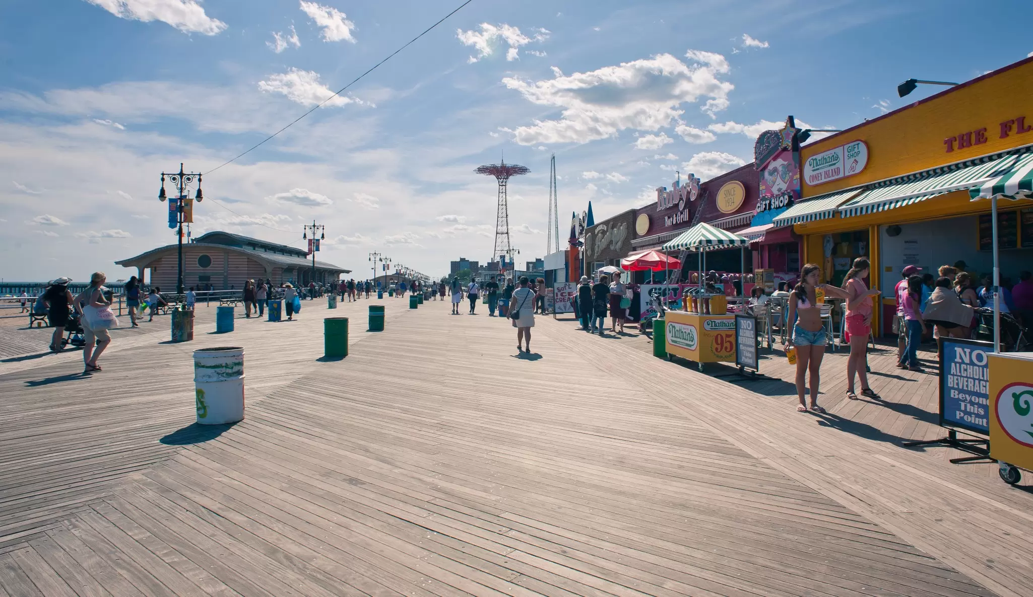 NEW YORK - JUNE 27: Riegelmann Boardwalk with Parachute Jump in the background on June 27, 2012 in Coney Island, NY. The Parachute Jump is 262 feet (80 m) tall and weighing 170 tons (150 tonnes)., License Type: media, Download Time: 2024-09-01T16:39:39.000Z, User: pinkjozie64, Editorial: true, purchase_order: 6530, job: Global Publishing WIP, client: Experience Mew York 2, other: Jo-anne Riddell