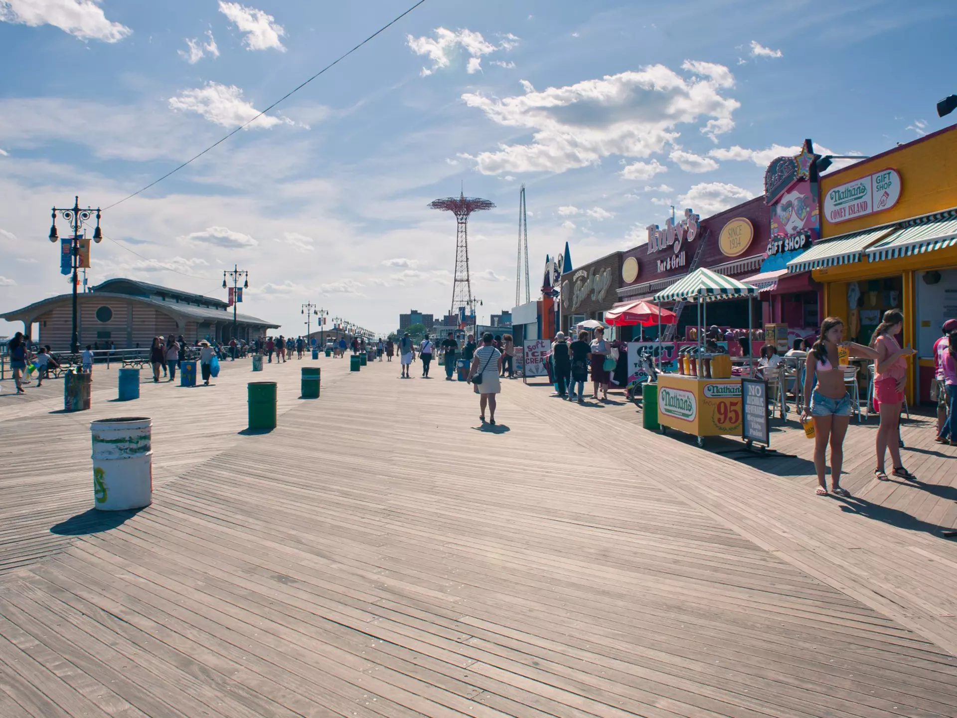 NEW YORK - JUNE 27: Riegelmann Boardwalk with Parachute Jump in the background on June 27, 2012 in Coney Island, NY. The Parachute Jump is 262 feet (80 m) tall and weighing 170 tons (150 tonnes)., License Type: media, Download Time: 2024-09-01T16:39:39.000Z, User: pinkjozie64, Editorial: true, purchase_order: 6530, job: Global Publishing WIP, client: Experience Mew York 2, other: Jo-anne Riddell