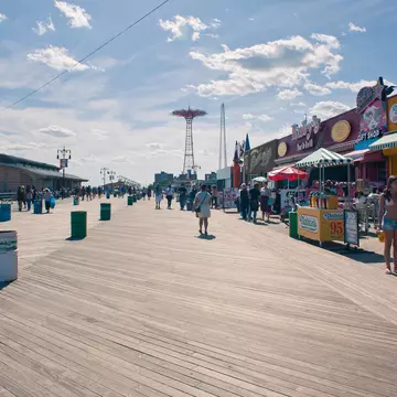 NEW YORK - JUNE 27: Riegelmann Boardwalk with Parachute Jump in the background on June 27, 2012 in Coney Island, NY. The Parachute Jump is 262 feet (80 m) tall and weighing 170 tons (150 tonnes)., License Type: media, Download Time: 2024-09-01T16:39:39.000Z, User: pinkjozie64, Editorial: true, purchase_order: 6530, job: Global Publishing WIP, client: Experience Mew York 2, other: Jo-anne Riddell