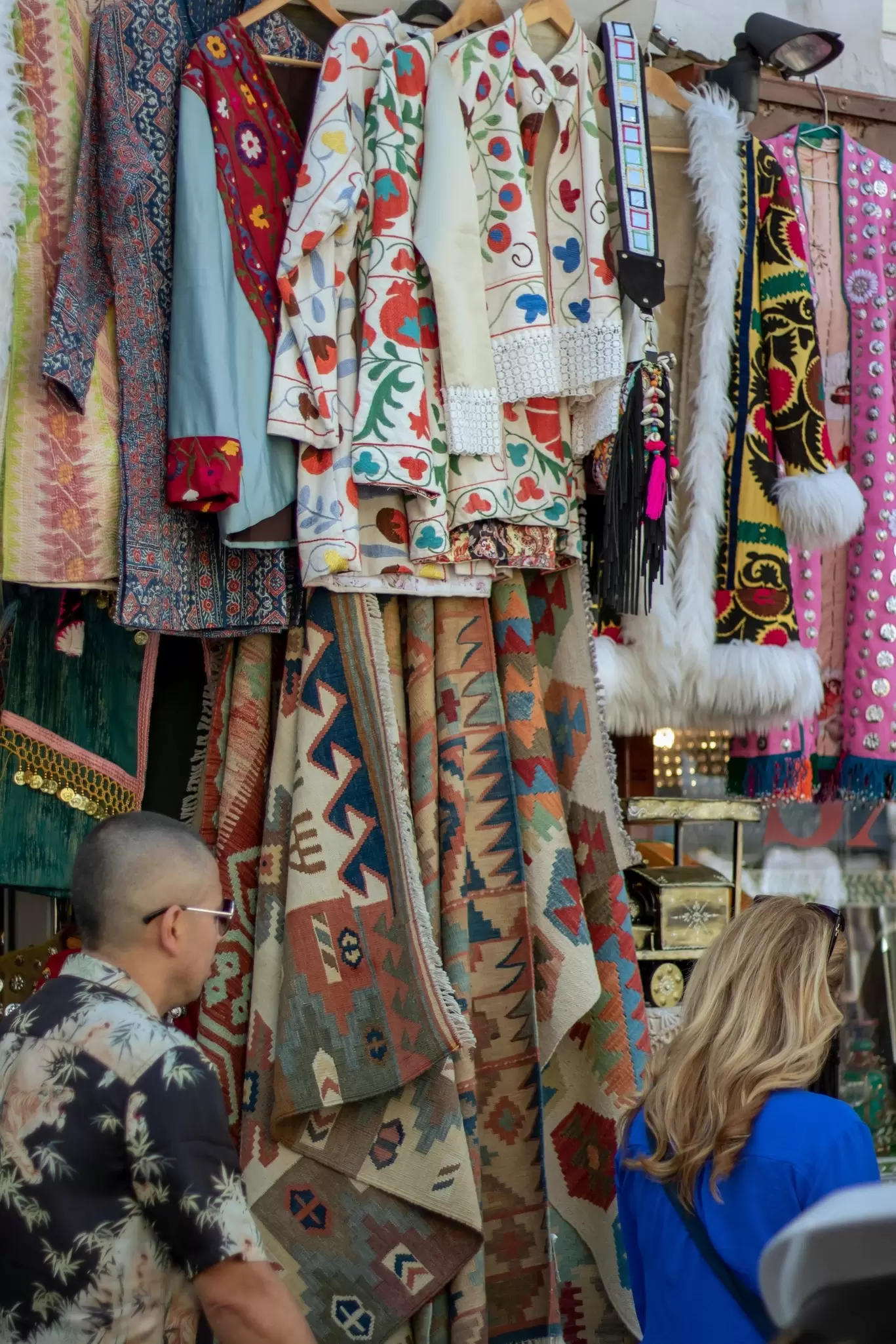 People walking past a clothing stand at Portobello Market in London, UK.