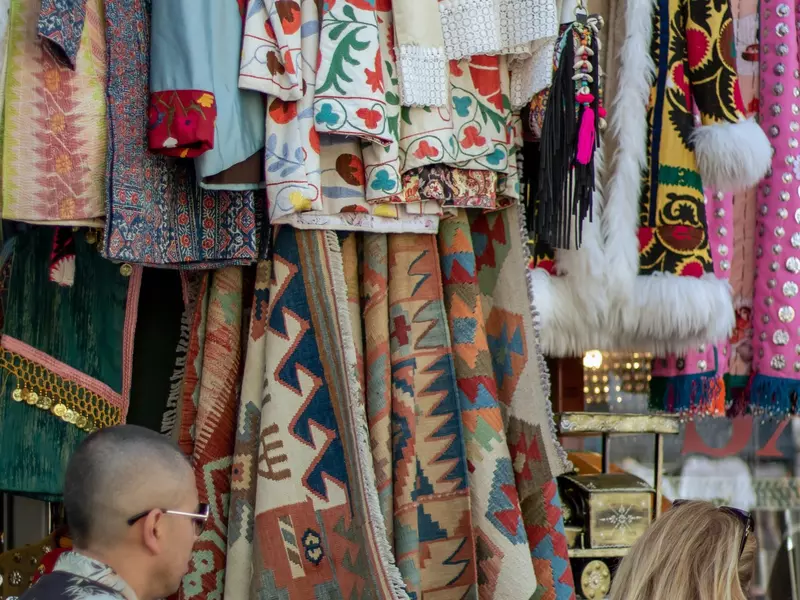 Clothes stand at Portobello Market with people walking by