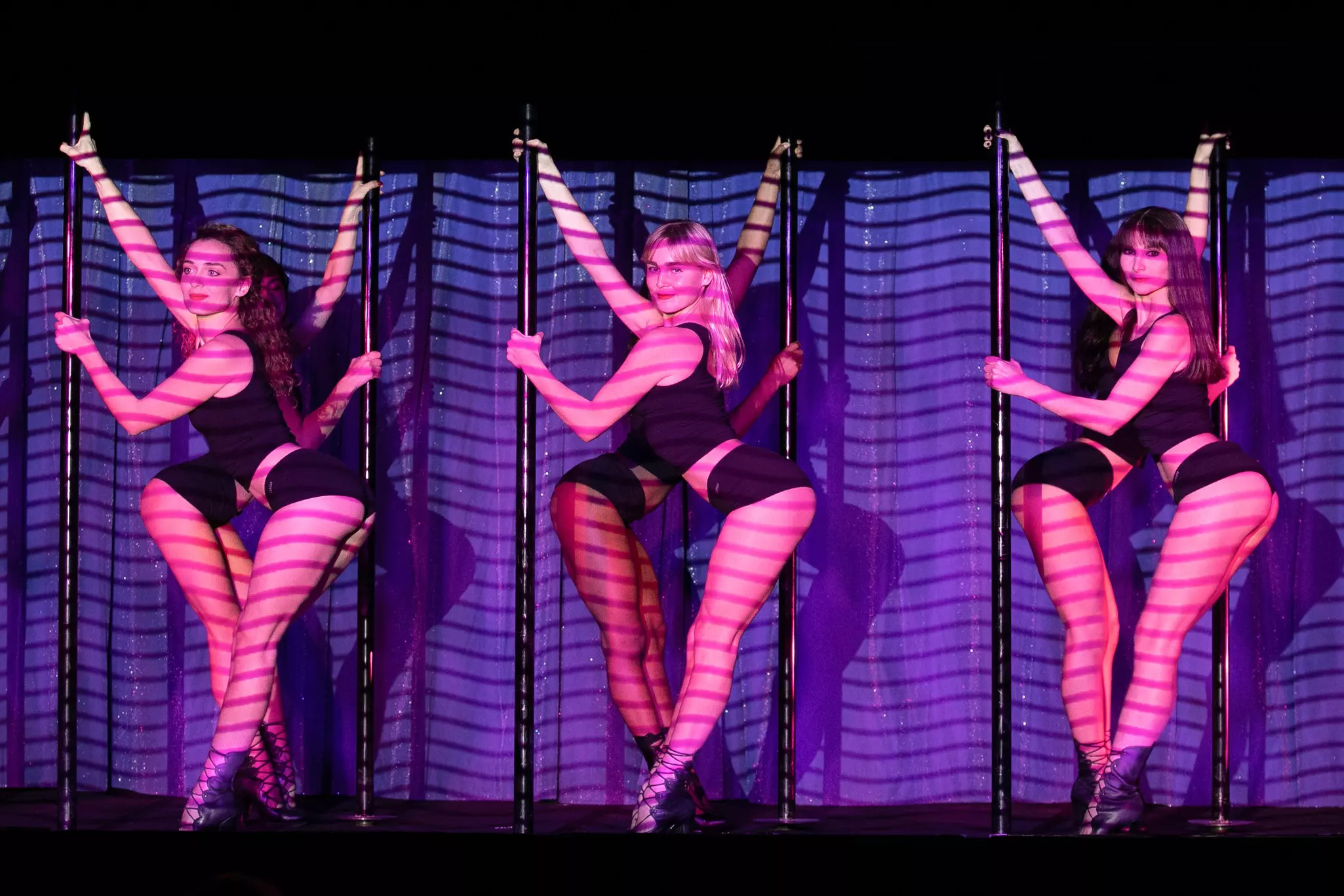 Dancers holding poles at the Crazy Horse