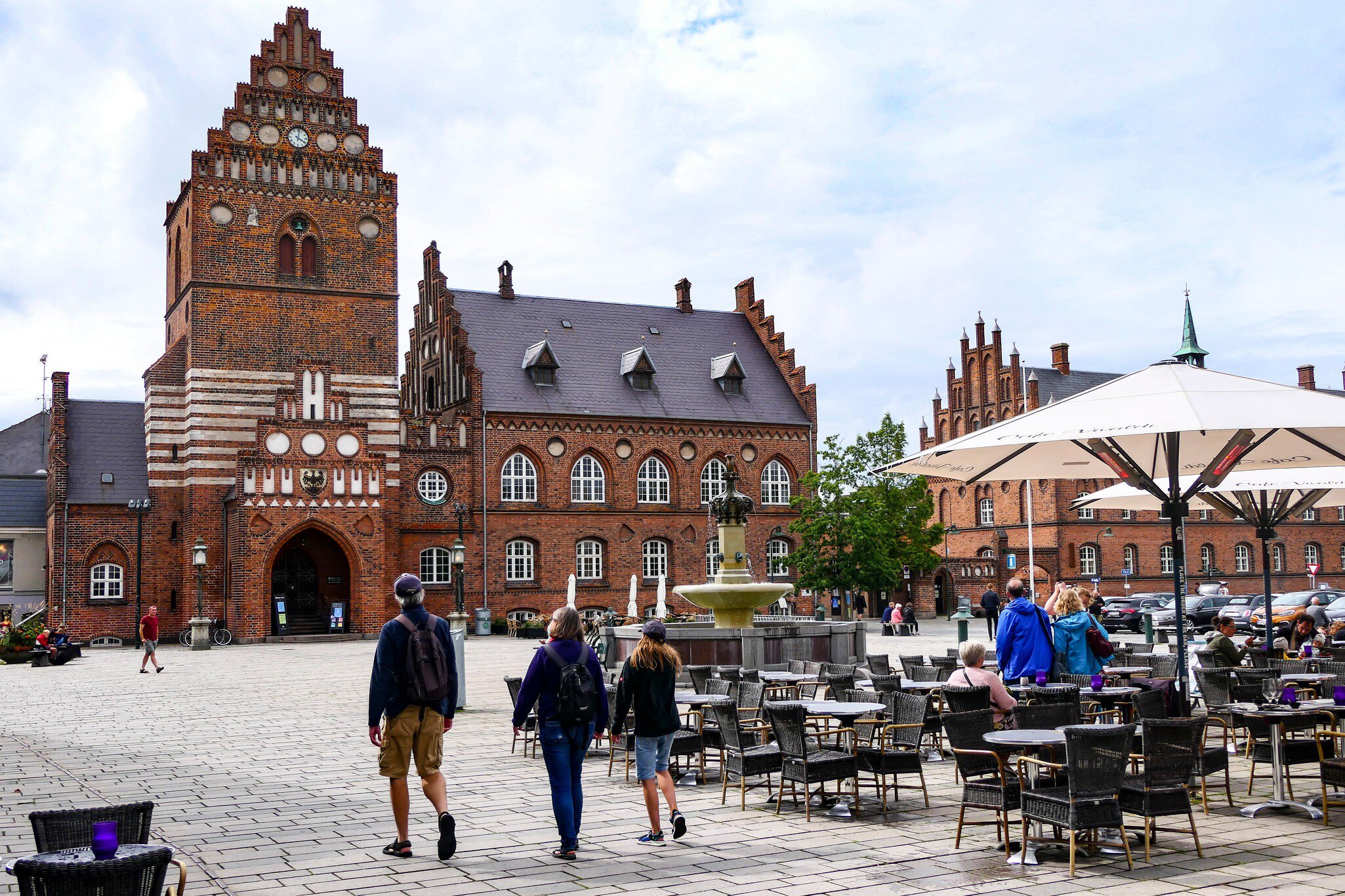 People walking towards Sankt Laurentius and main square of Roskilde, Denmark.
