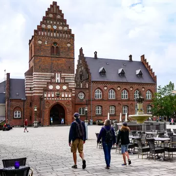 People walking towards Sankt Laurentius and main square of Roskilde, Denmark.